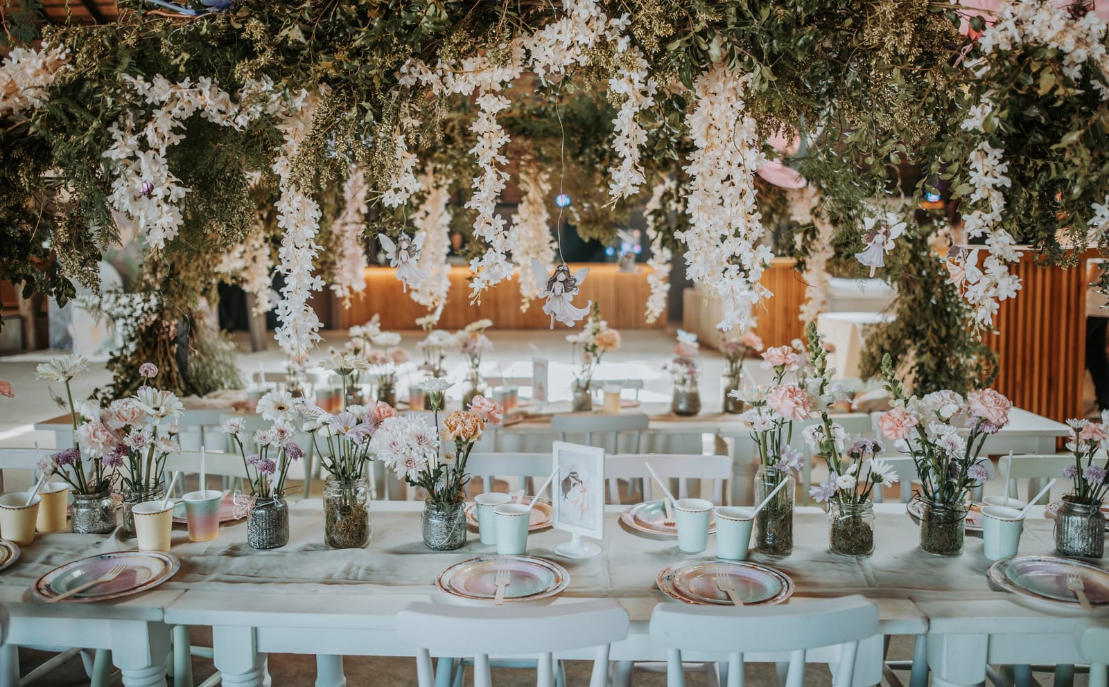 Cumpleaños infantil temática hadas — mesa larga ambientada con flores por Cecilia Eriksson Eventos
